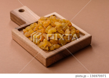 Sweet, dry, golden or yellow raisin made from grapes are a healthy, nutritious food. Golden raisins Sweet, dry, golden or yellow raisin made from grapes are a healthy, nutritious food. Golden raisins 136970971