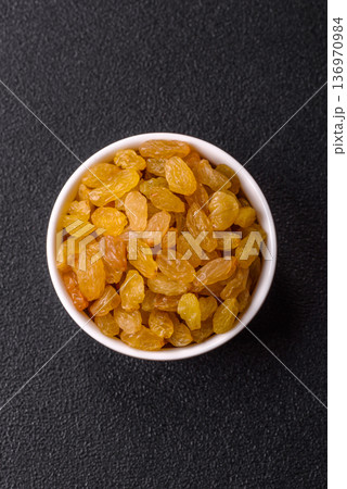 Sweet, dry, golden or yellow raisin made from grapes are a healthy, nutritious food. Golden raisins 136970984