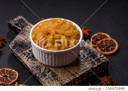 Sweet, dry, golden or yellow raisin made from grapes are a healthy, nutritious food. Golden raisins 136970986