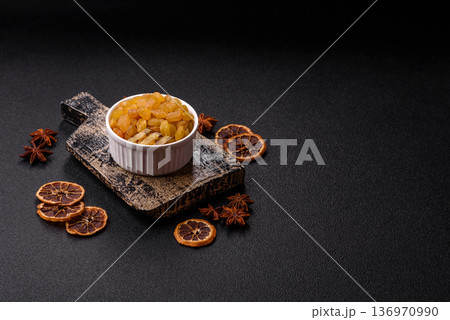 Sweet, dry, golden or yellow raisin made from grapes are a healthy, nutritious food. Golden raisins 136970990