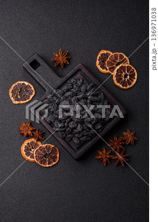 Sweet, dry black or blue raisins made from grapes are a healthy and nutritious food. Black raisins Sweet, dry black or blue raisins made from grapes are a healthy and nutritious food. Black raisins 136971038