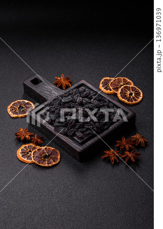 Sweet, dry black or blue raisins made from grapes are a healthy and nutritious food. Black raisins Sweet, dry black or blue raisins made from grapes are a healthy and nutritious food. Black raisins 136971039