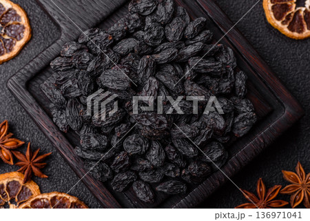 Sweet, dry black or blue raisins made from grapes are a healthy and nutritious food. Black raisins 136971041