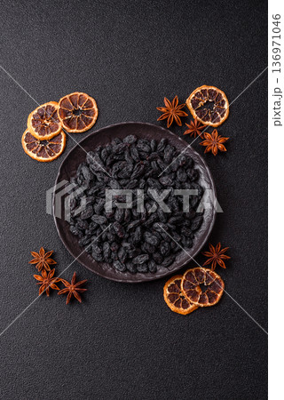 Sweet, dry black or blue raisins made from grapes are a healthy and nutritious food. Black raisins 136971046