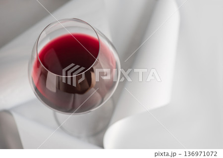 Red Wine Glass on Minimal Gray Background. Elegant Modern Beverage Concept Red Wine Glass on Minimal Gray Background. Elegant Modern Beverage Concept 136971072