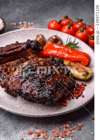 Grilled or barbecued pork or beef ribs, meat with red sauce for the dinner table. Grilled ribs 136971106