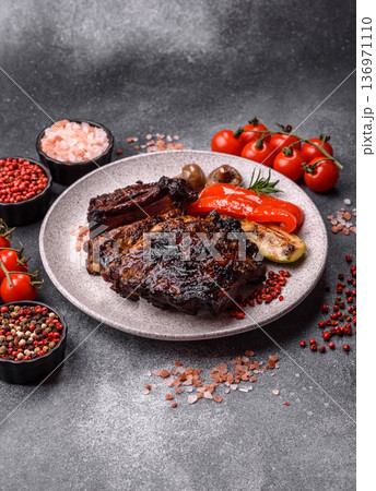 Grilled or barbecued pork or beef ribs, meat with red sauce for the dinner table. Grilled ribs 136971110