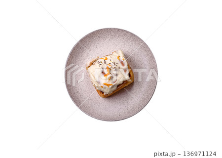 Cinnabon, a sweet cinnamon pastry, a high calorie bun or roll. Cinnabon with cinnamon Cinnabon, a sweet cinnamon pastry, a high calorie bun or roll. Cinnabon with cinnamon 136971124