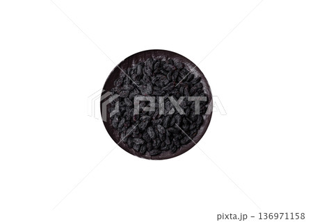 Sweet, dry black or blue raisins made from grapes are a healthy and nutritious food. Black raisins 136971158