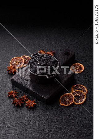 Sweet, dry black or blue raisins made from grapes are a healthy and nutritious food. Black raisins 136971175