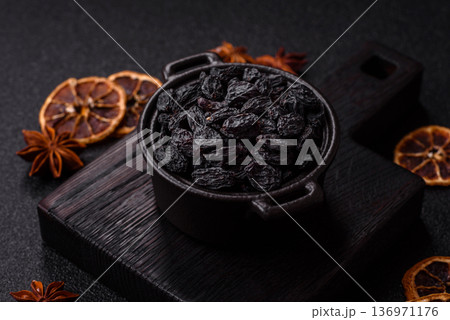 Sweet, dry black or blue raisins made from grapes are a healthy and nutritious food. Black raisins 136971176
