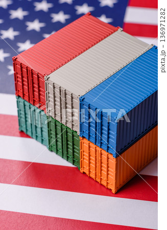 Cargo containers on the US flag as a conceptual backdrop for goods export and logistics. Cargo containers Cargo containers on the US flag as a conceptual backdrop for goods export and logistics. Cargo containers 136971282