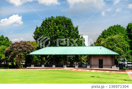 Exterior view of the North Pavilion structure with a green roof surrounded by green grass and trees at Centennial Olympic Park in Atlanta, Georgia, United States. Exterior view of the North Pavilion structure with a green roof surrounded by green grass and trees at Centennial Olympic Park in Atlanta, Georgia, United States. 136971304