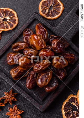 Dried sweet dates, natural tropical fruits for a healthy diet. Dried dates Dried sweet dates, natural tropical fruits for a healthy diet. Dried dates 136971380