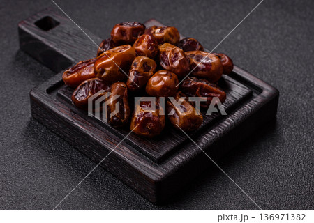 Dried sweet dates, natural tropical fruits for a healthy diet. Dried dates Dried sweet dates, natural tropical fruits for a healthy diet. Dried dates 136971382