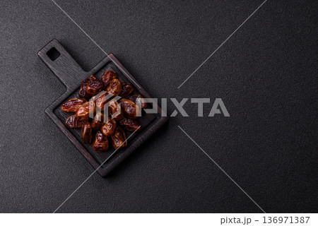 Dried sweet dates, natural tropical fruits for a healthy diet. Dried dates Dried sweet dates, natural tropical fruits for a healthy diet. Dried dates 136971387