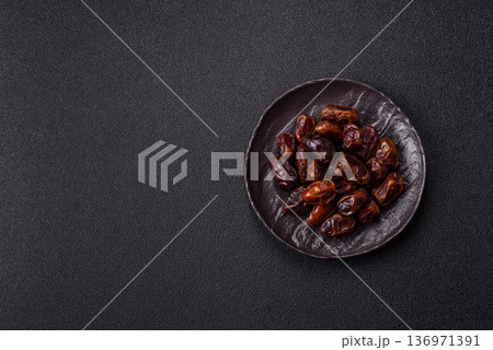 Dried sweet dates, natural tropical fruits for a healthy diet. Dried dates Dried sweet dates, natural tropical fruits for a healthy diet. Dried dates 136971391