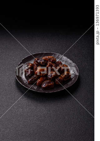 Dried sweet dates, natural tropical fruits for a healthy diet. Dried dates Dried sweet dates, natural tropical fruits for a healthy diet. Dried dates 136971393