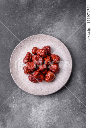 Red dried dates, the Chinese sweet fruit jujube, as a healthy food. Red dates, jujube Red dried dates, the Chinese sweet fruit jujube, as a healthy food. Red dates, jujube 136971744