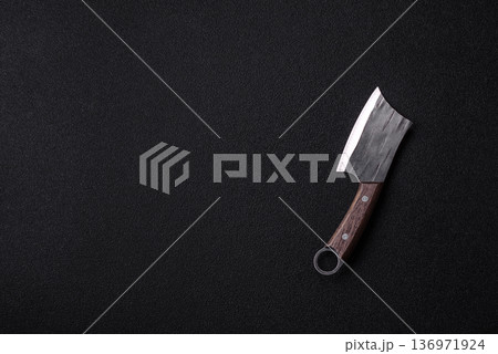 A kitchen cleaver or butcher's knife for cutting meat. A butcher's cleaver A kitchen cleaver or butcher's knife for cutting meat. A butcher's cleaver 136971924