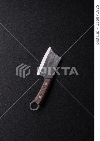 A kitchen cleaver or butcher's knife for cutting meat. A butcher's cleaver 136971925