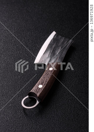 A kitchen cleaver or butcher's knife for cutting meat. A butcher's cleaver A kitchen cleaver or butcher's knife for cutting meat. A butcher's cleaver 136971928