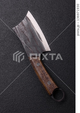 A kitchen cleaver or butcher's knife for cutting meat. A butcher's cleaver A kitchen cleaver or butcher's knife for cutting meat. A butcher's cleaver 136971930