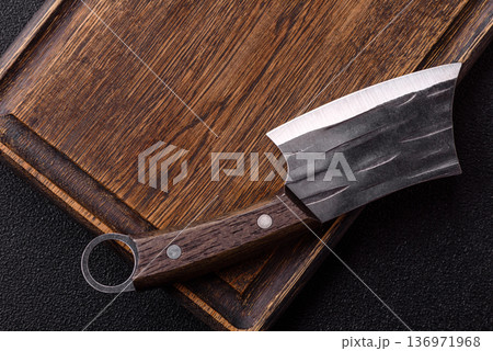 Empty wooden cutting board with a knife for food preparation. An empty wooden cutting board 136971968