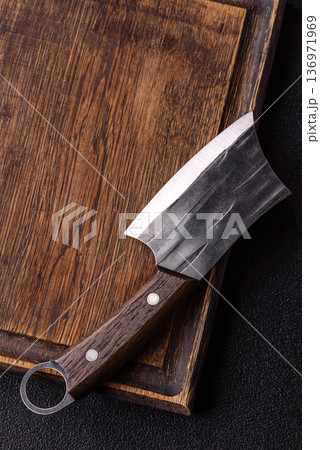 Empty wooden cutting board with a knife for food preparation. An empty wooden cutting board Empty wooden cutting board with a knife for food preparation. An empty wooden cutting board 136971969