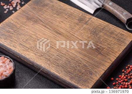 Empty wooden cutting board with a knife for food preparation. An empty wooden cutting board 136971970