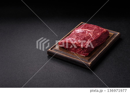A piece of raw beef, a tenderloin for grilling or barbecue. Raw beef 136971977