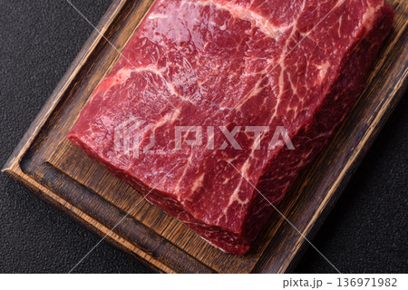A piece of raw beef, a tenderloin for grilling or barbecue. Raw beef 136971982
