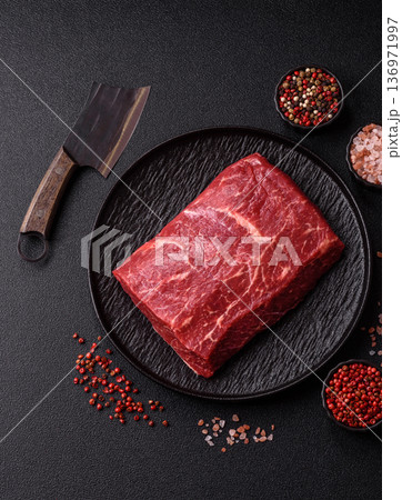 A piece of raw beef, a tenderloin for grilling or barbecue. Raw beef A piece of raw beef, a tenderloin for grilling or barbecue. Raw beef 136971997