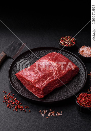 A piece of raw beef, a tenderloin for grilling or barbecue. Raw beef A piece of raw beef, a tenderloin for grilling or barbecue. Raw beef 136971998
