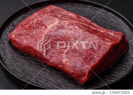 A piece of raw beef, a tenderloin for grilling or barbecue. Raw beef 136972003