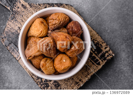 Dried fig are a sweet, healthy fruit for vegans and vegetarians. Dried fig as a food background Dried fig are a sweet, healthy fruit for vegans and vegetarians. Dried fig as a food background 136972089