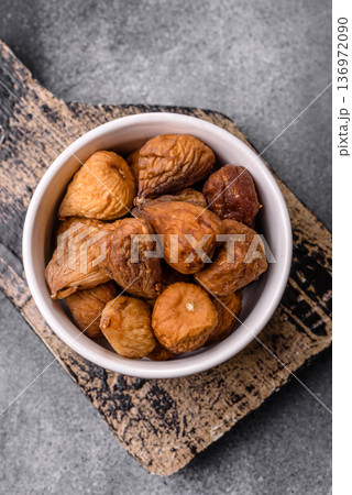 Dried fig are a sweet, healthy fruit for vegans and vegetarians. Dried fig as a food background 136972090