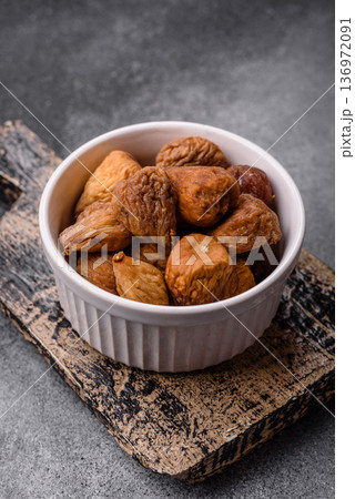 Dried fig are a sweet, healthy fruit for vegans and vegetarians. Dried fig as a food background Dried fig are a sweet, healthy fruit for vegans and vegetarians. Dried fig as a food background 136972091
