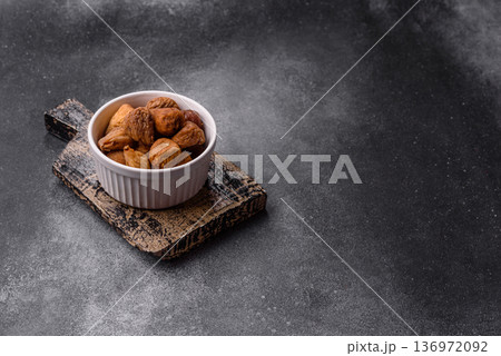 Dried fig are a sweet, healthy fruit for vegans and vegetarians. Dried fig as a food background Dried fig are a sweet, healthy fruit for vegans and vegetarians. Dried fig as a food background 136972092