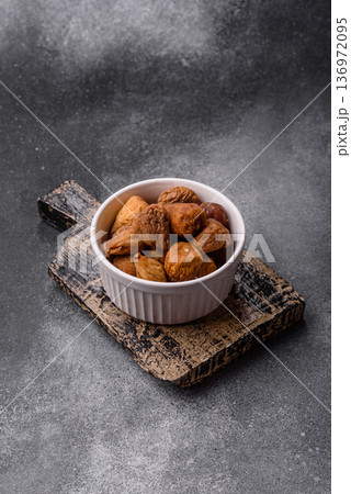 Dried fig are a sweet, healthy fruit for vegans and vegetarians. Dried fig as a food background 136972095