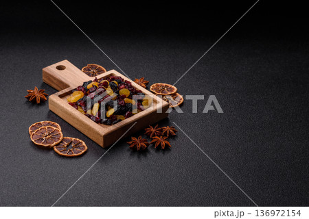 Dried cranberries, yellow and black sweet raisins as ingredients for a breakfast. Raisins and cranberries 136972154