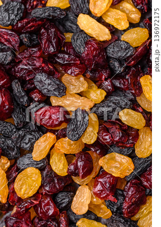 Dried cranberries, yellow and black sweet raisins as ingredients for a breakfast. Raisins and cranberries 136972175