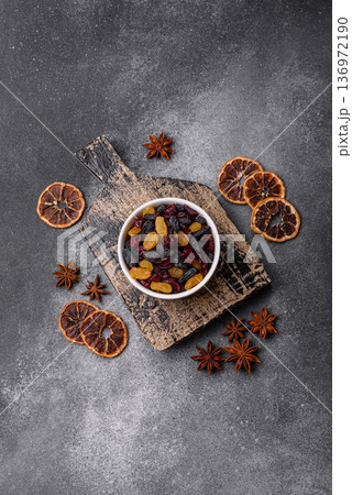 Dried cranberries, yellow and black sweet raisins as ingredients for a breakfast. Raisins and cranberries Dried cranberries, yellow and black sweet raisins as ingredients for a breakfast. Raisins and cranberries 136972190