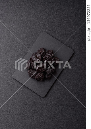 Sweet dried plums or prunes, organic dehydrated fruit for dietary nutrition. Prunes or dried plums 136972223
