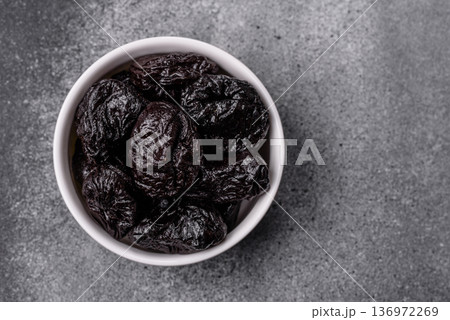 Sweet dried plums or prunes, organic dehydrated fruit for dietary nutrition. Prunes or dried plums Sweet dried plums or prunes, organic dehydrated fruit for dietary nutrition. Prunes or dried plums 136972269