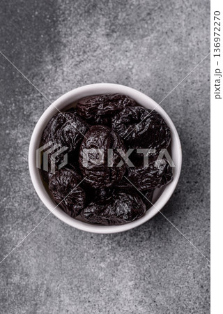 Sweet dried plums or prunes, organic dehydrated fruit for dietary nutrition. Prunes or dried plums 136972270