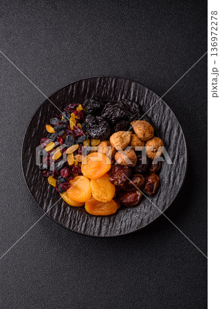 A variety of dried fruits, apricots, prunes, cranberries, raisins, figs, and dates for a healthy breakfast. A dried fruit mix A variety of dried fruits, apricots, prunes, cranberries, raisins, figs, and dates for a healthy breakfast. A dried fruit mix 136972278