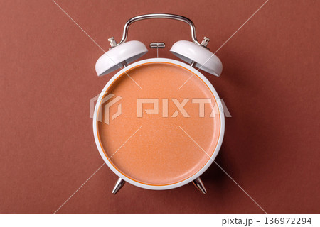 Vintage alarm clock on brown surface as a conceptual background for deadlines for tasks Vintage alarm clock on brown surface as a conceptual background for deadlines for tasks 136972294