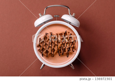 Vintage alarm clock on brown surface as a conceptual background for deadlines for tasks Vintage alarm clock on brown surface as a conceptual background for deadlines for tasks 136972301
