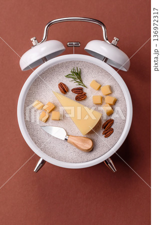 Vintage alarm clock on brown surface as a conceptual background for deadlines for tasks 136972317